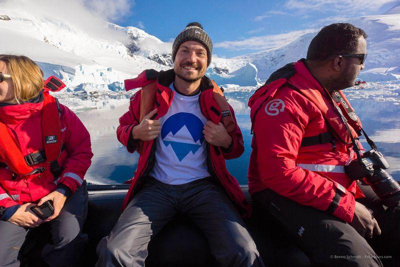 Our founder Benno with Polartours-shirt in front of icebergs in the Antarctica